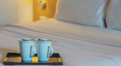 close-up-twin-welcome-coffee-cup-white-bed-hotel-room-hotel-well-hospitality-vacation-travel-concept_1150-13594